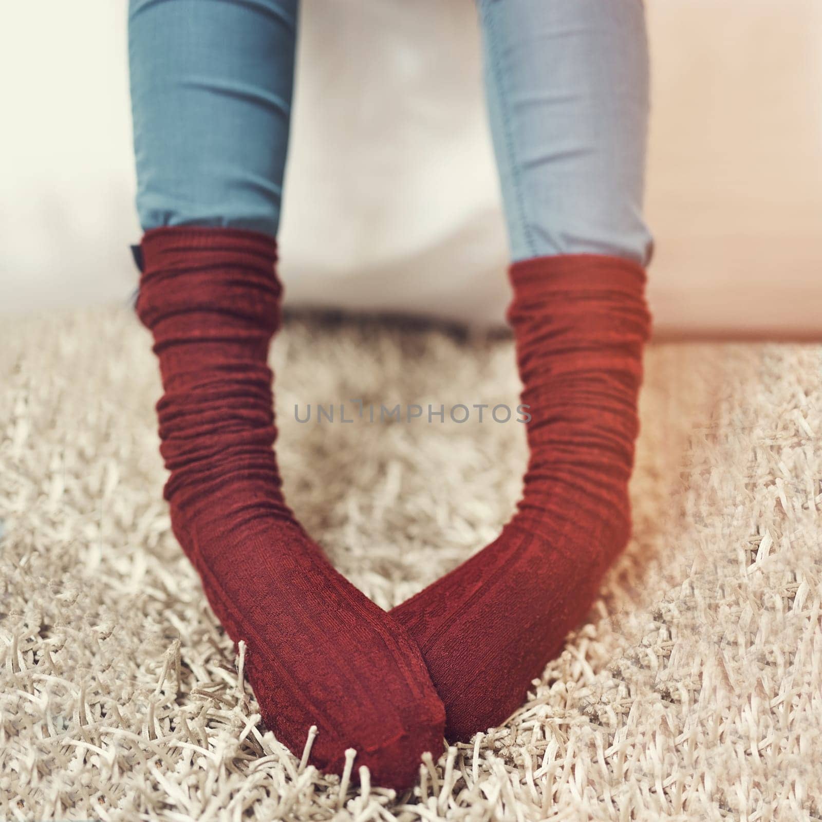 I love them so much I wear it to bed. a young woman wearing warm sock. by YuriArcurs