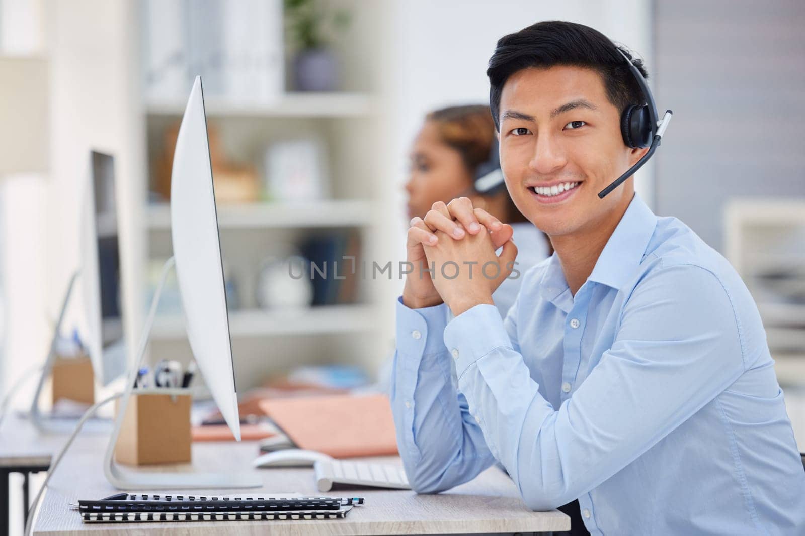 Business man, portrait and call center consultation in a office working on a computer. Smile, Asian male worker and web support advice of a contact us employee with professional communication at job by YuriArcurs