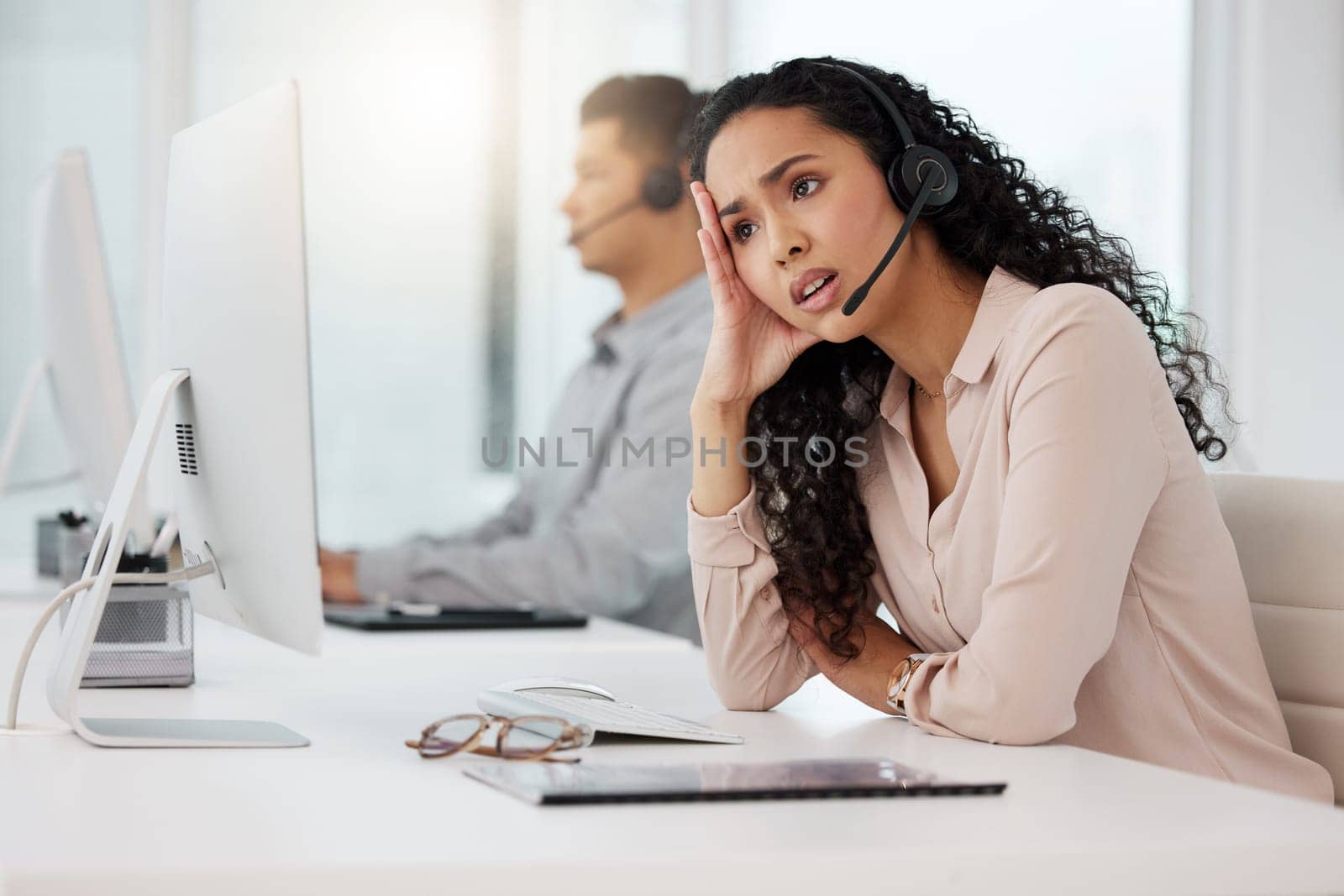 Business woman, call center and frustrated in customer service, stress or burnout at office. Annoyed and tired female person, consultant or agent talking to difficult client or complaint at workplace by YuriArcurs