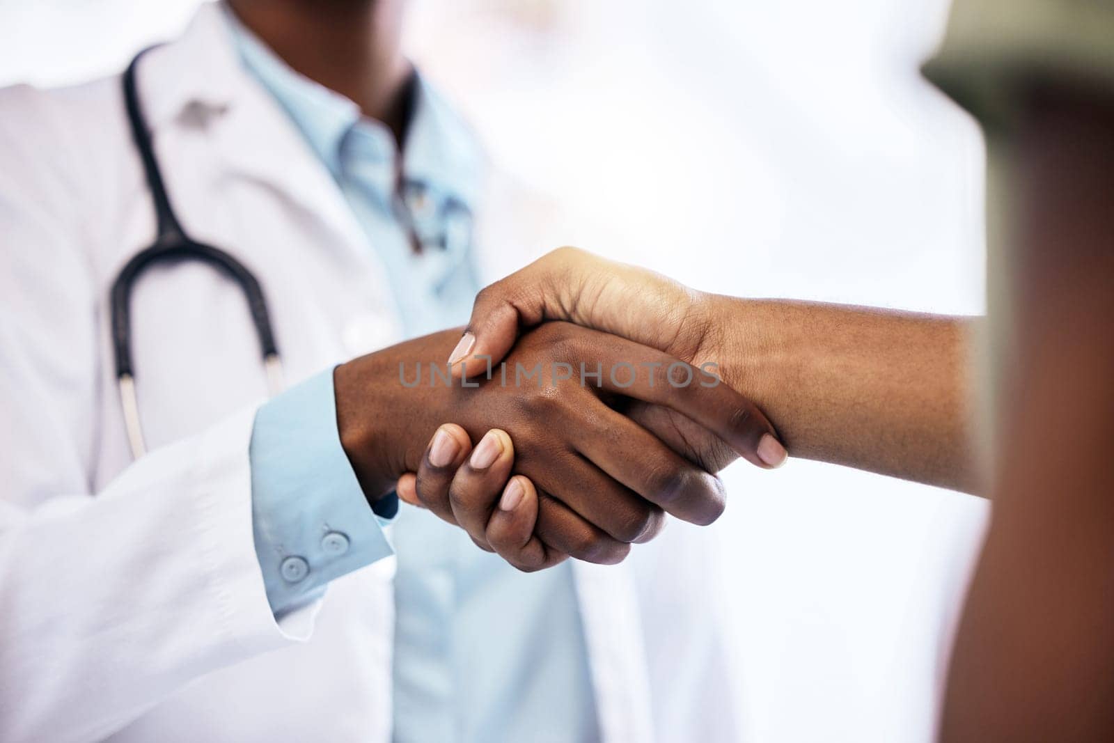 Handshake, welcome and a doctor meeting a patient in the hospital for healthcare, insurance or medical treatment. Medicine, trust or thank you with a health professional shaking hands in a clinic.