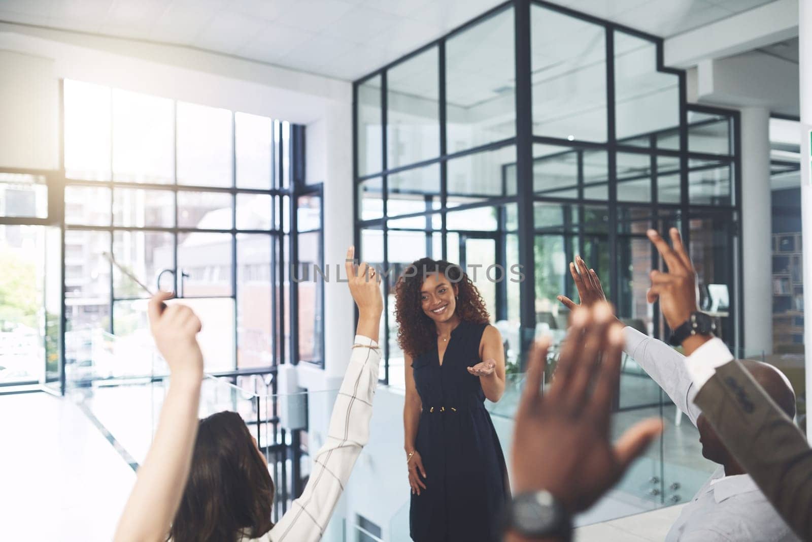 Well get through all your questions. Closeup shot of a group of businesspeople raising their hands during a presentation in an office