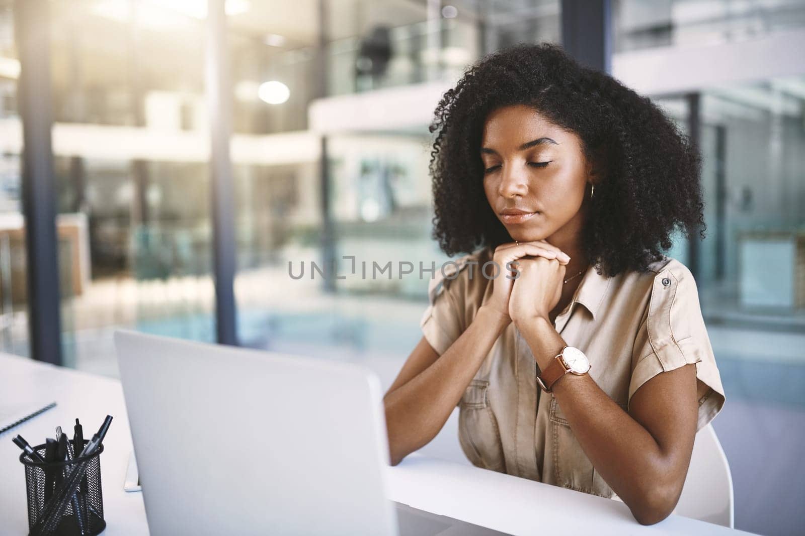 Not feeling it. a young businesswoman looking stressed at her desk in a modern office