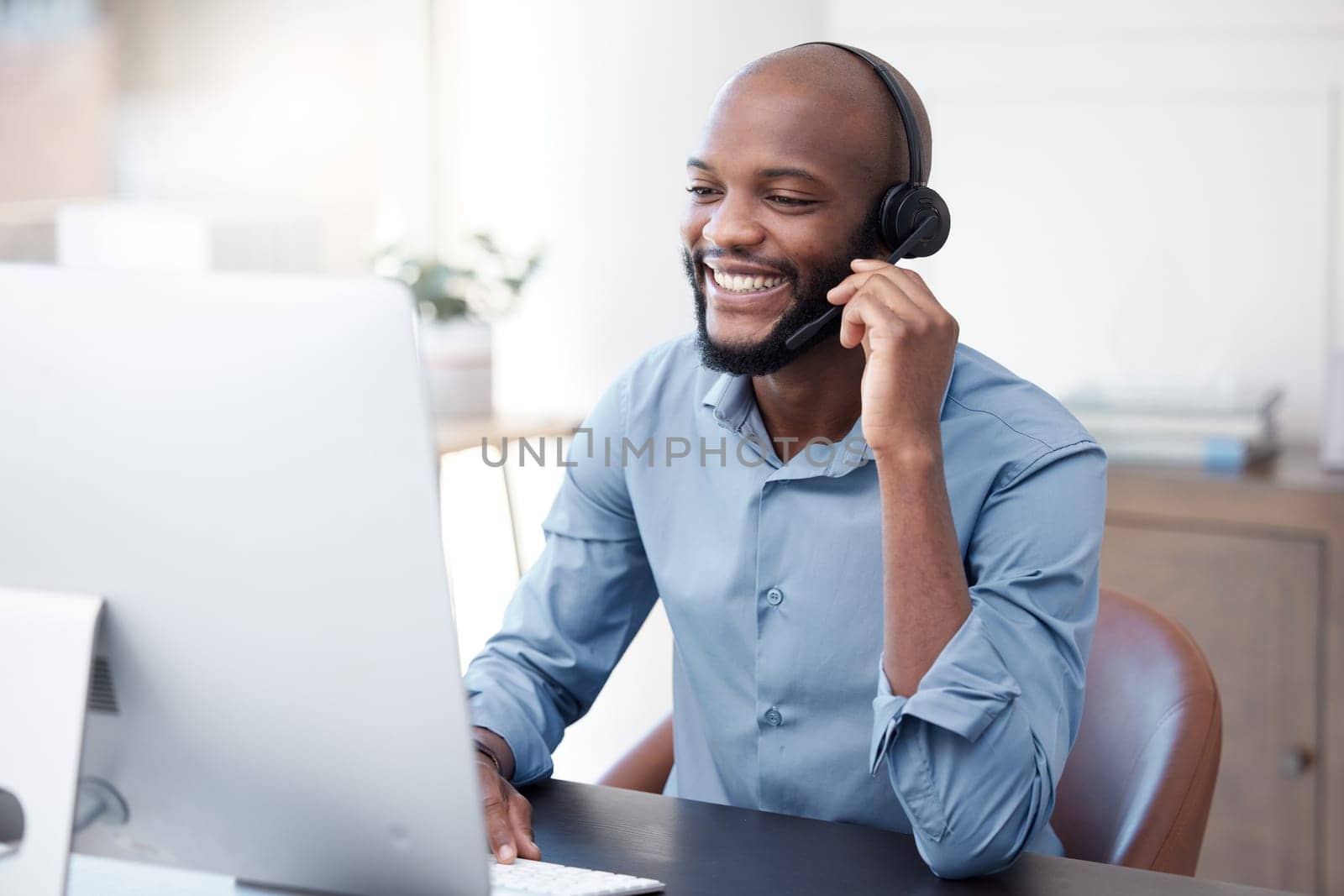 Black man, callcenter with phone call and contact us, communication with headset and CRM in office. Male consultant at computer, customer service or telemarketing, tech support and help desk worker by YuriArcurs