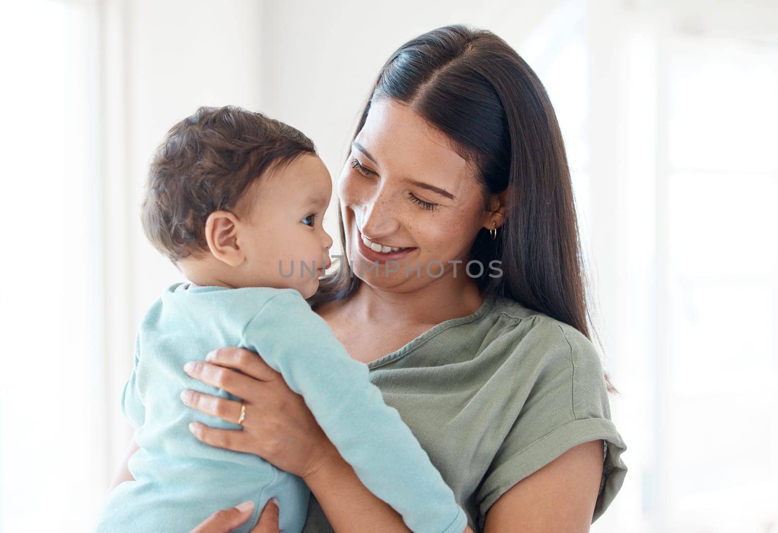 Smile, mother and holding baby in home for love, care and quality time together for childcare, development and growth. Mom carrying infant kid, newborn girl and support of comfort, bond and happiness.