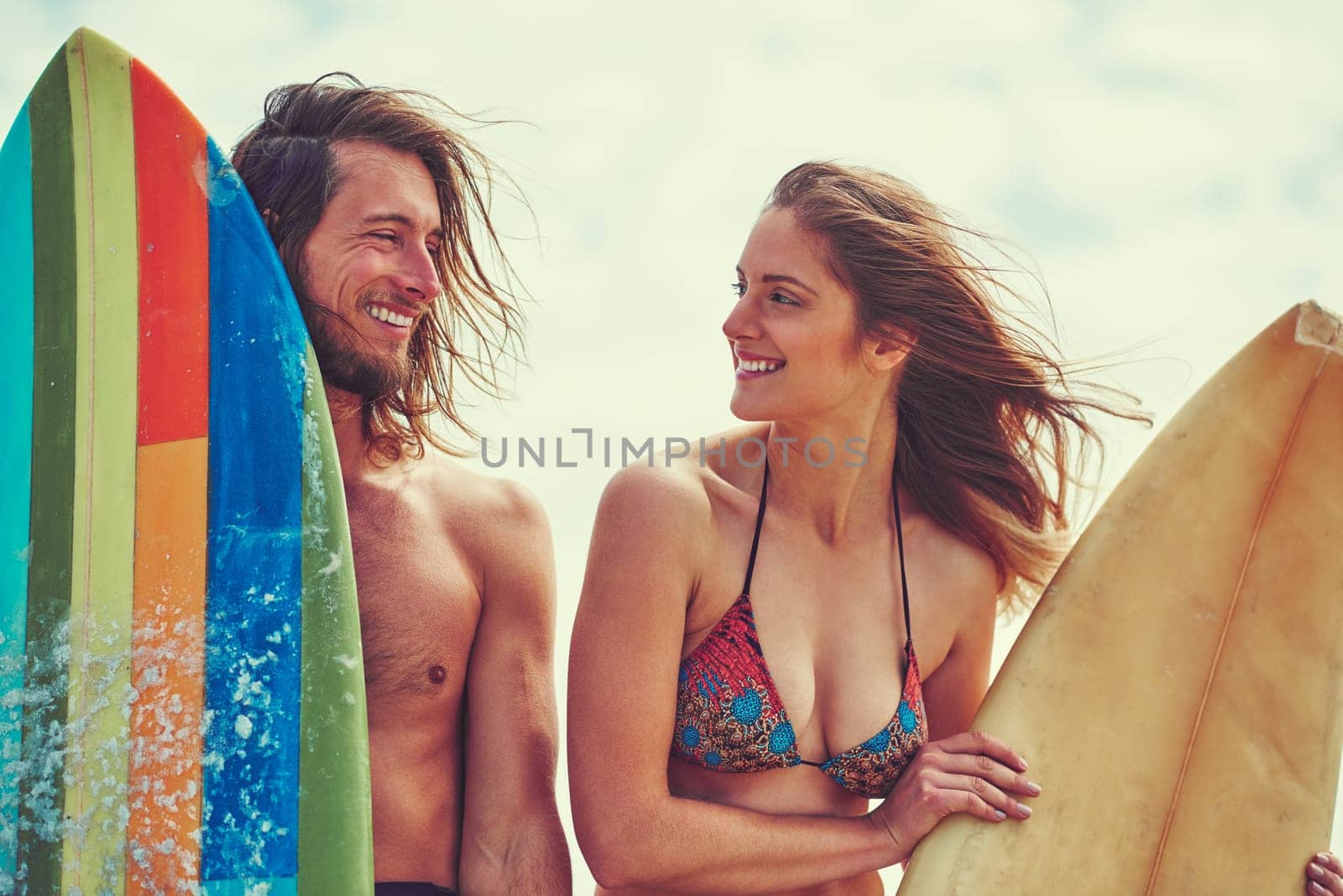 She had me at surfing. a young couple spending the day out surfing. by YuriArcurs