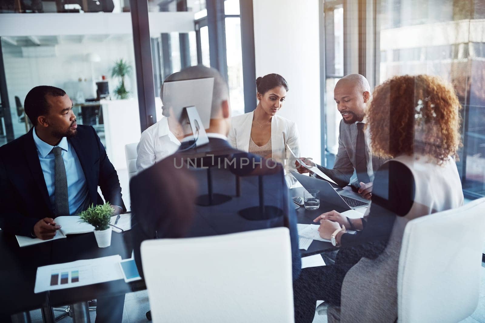 Working together for a shared goal. a team of professionals having a meeting in the boardroom at work