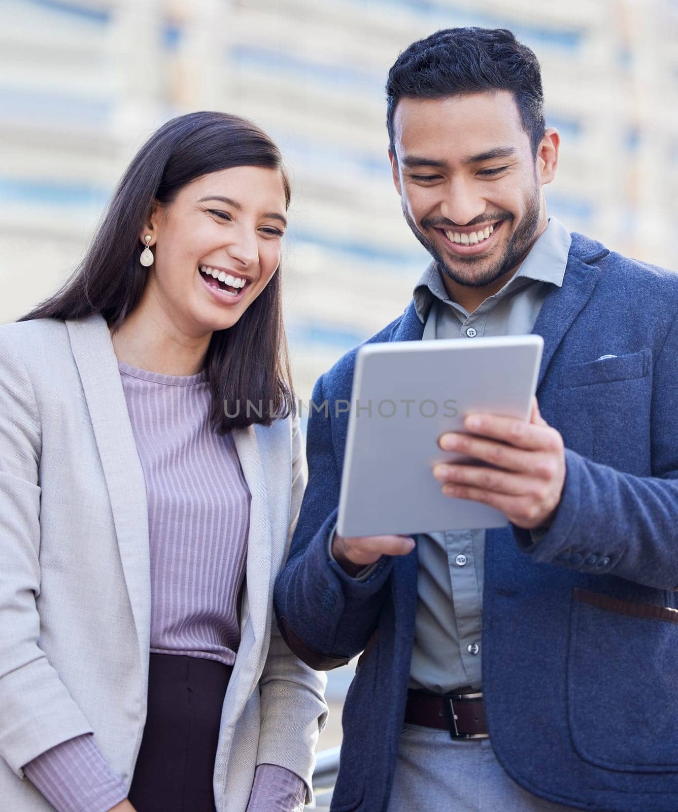Business people, tablet and team laughing outdoor in a city with internet connection for social media. Happy man and woman together on urban background with tech for networking, communication or app.