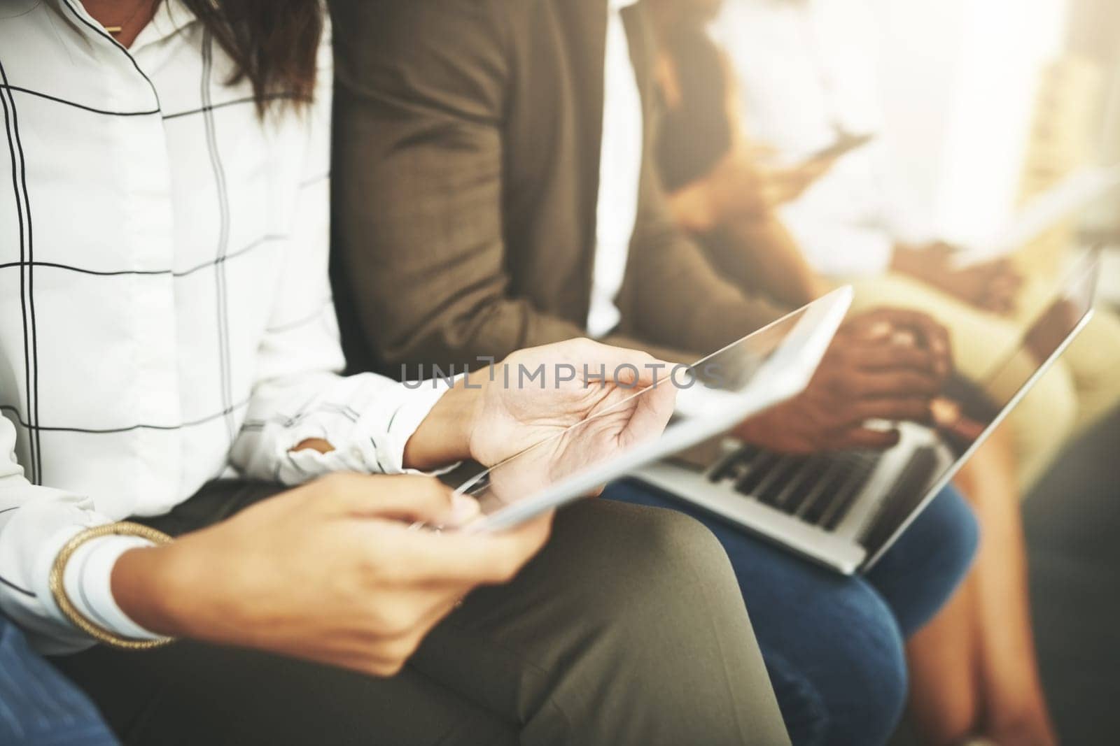 Connect to a world of business info. a group of businesspeople using their wireless devices while waiting in line. by YuriArcurs