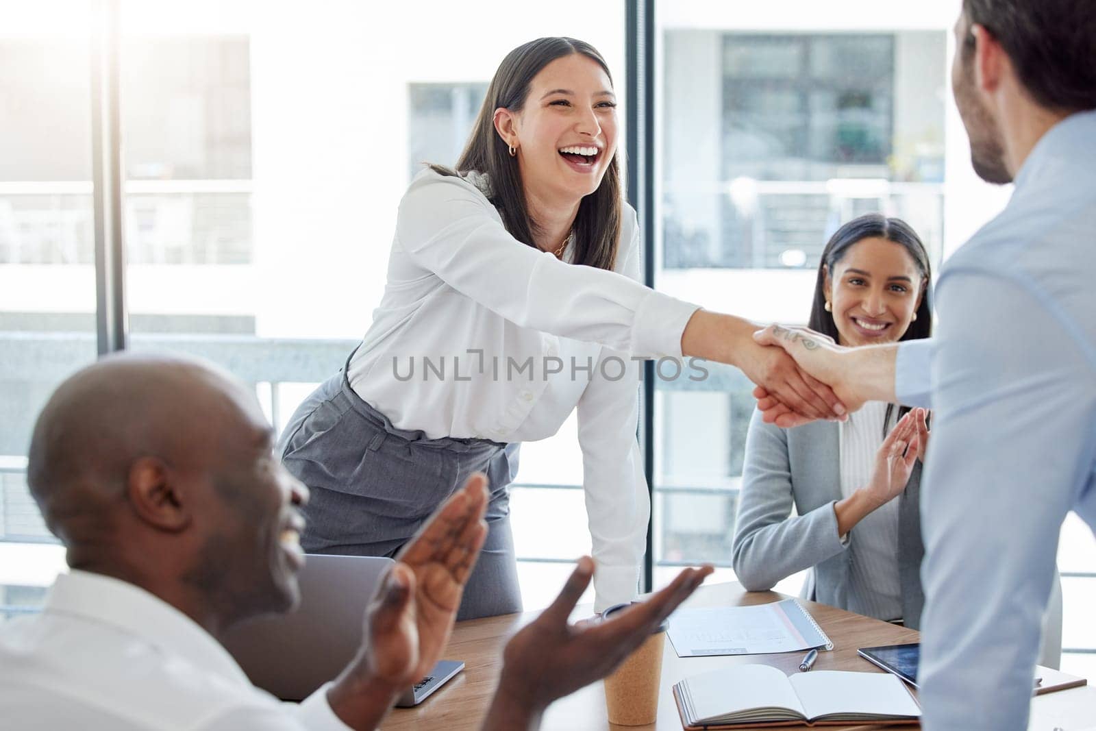 Professional, introduction and shaking hands at the office during a meeting with applause. Business person, welcome and congratulation for a collaboration in the workplace for hiring and teamwork