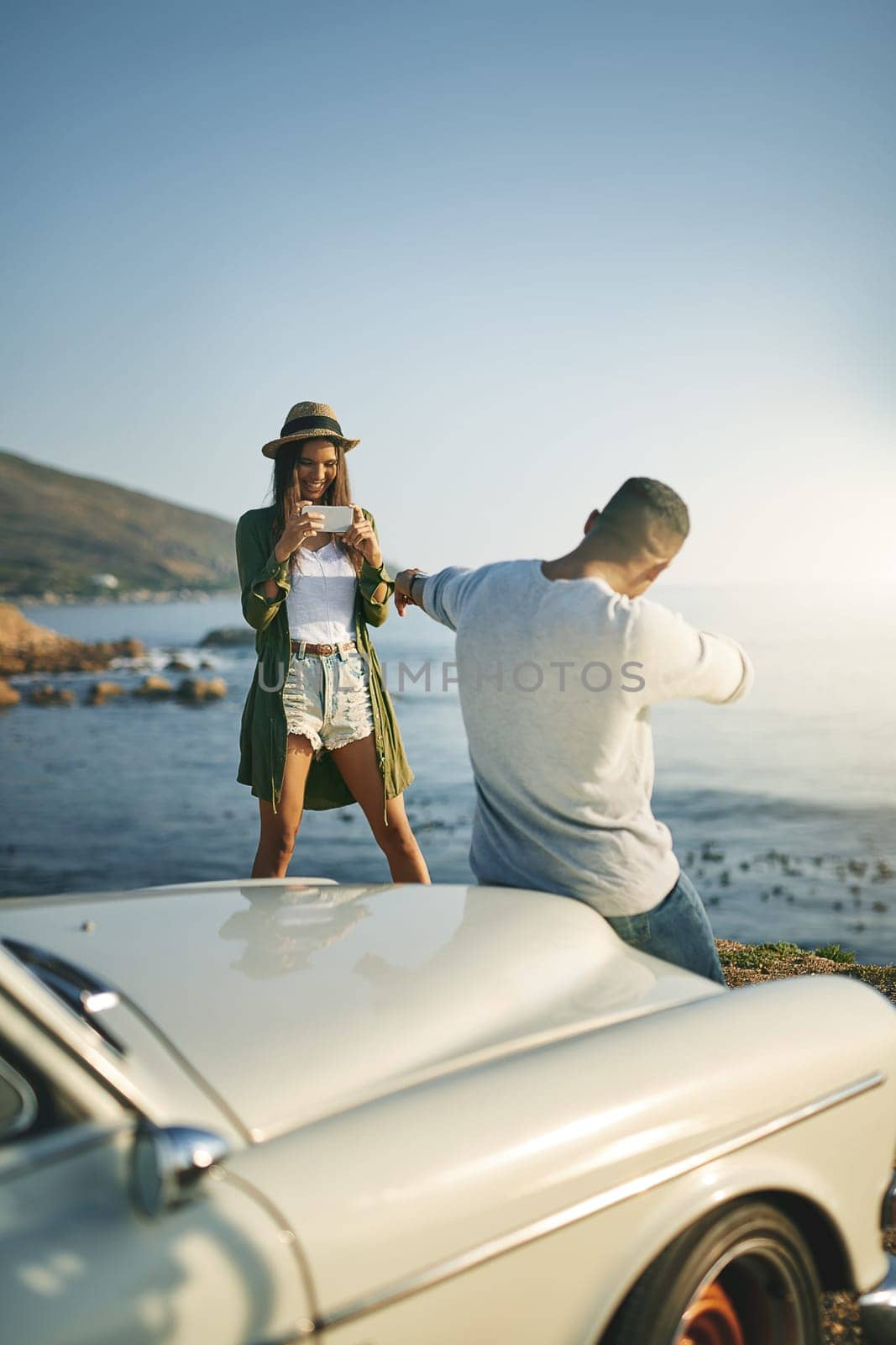 I want to post a picture of my hunk. a young couple making a stop at the beach while out on a roadtrip