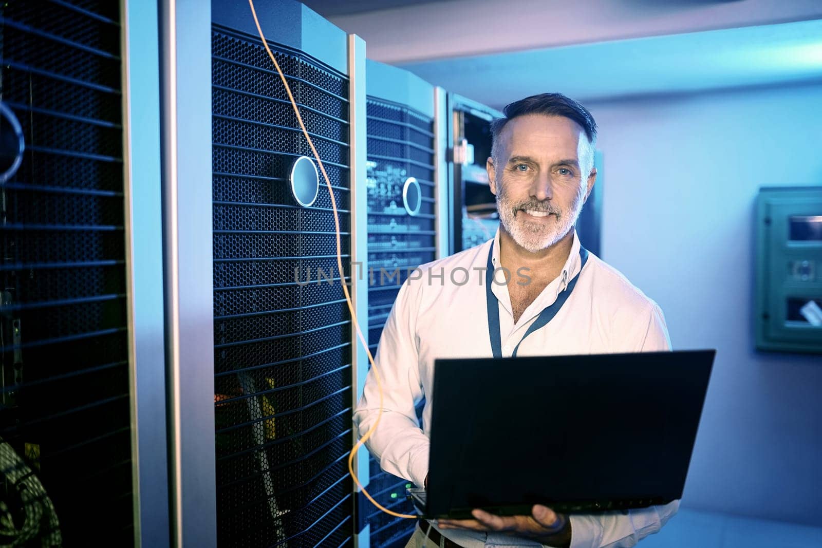 It might seem complex, but its simple to me. Portrait of a mature man using a laptop while working in a server room