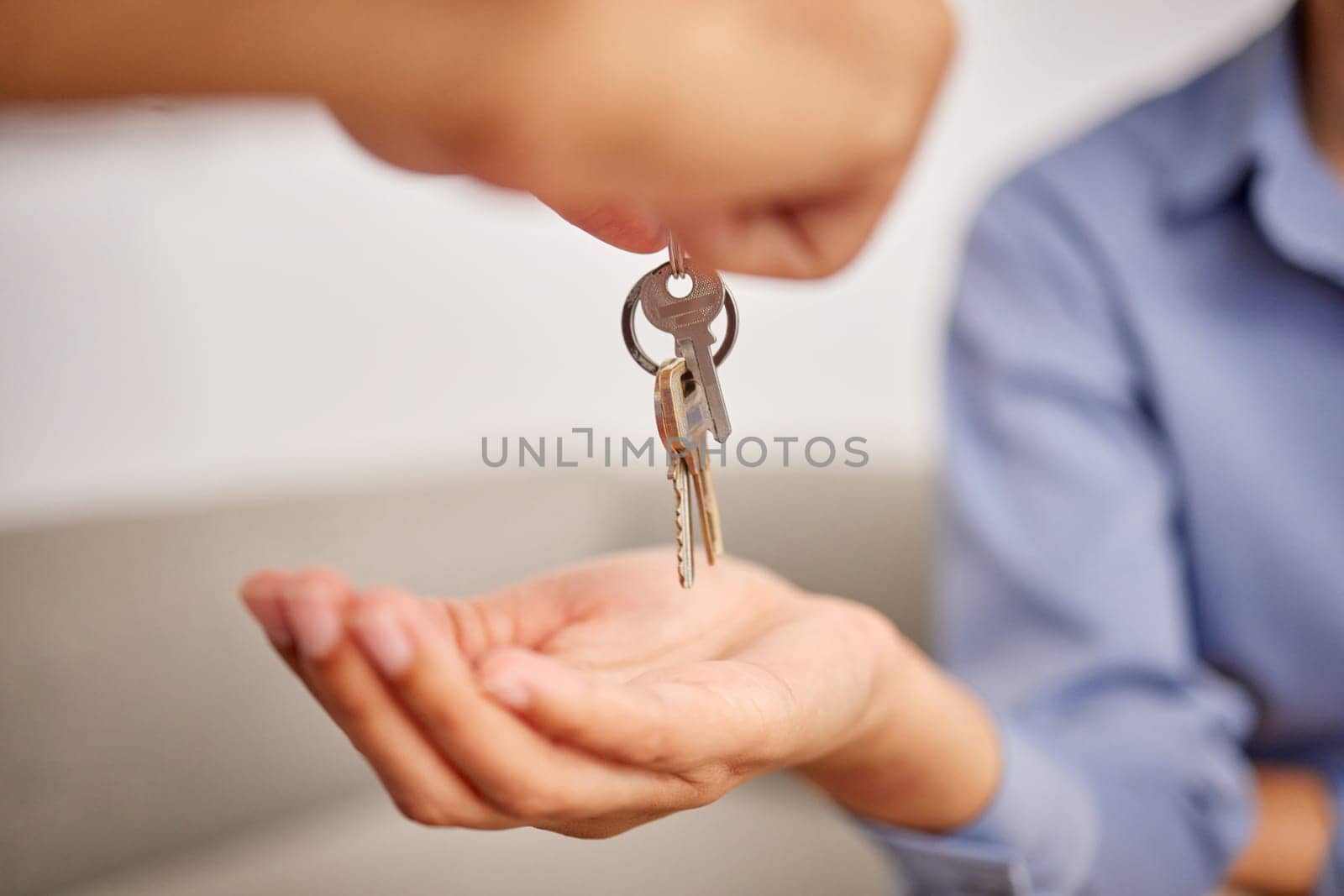 Hands, real estate and giving keys to customer after moving into new home. Property agent, realtor and handing over key to owner for sale, loan or mortgage investment in apartment, house or rent. by YuriArcurs