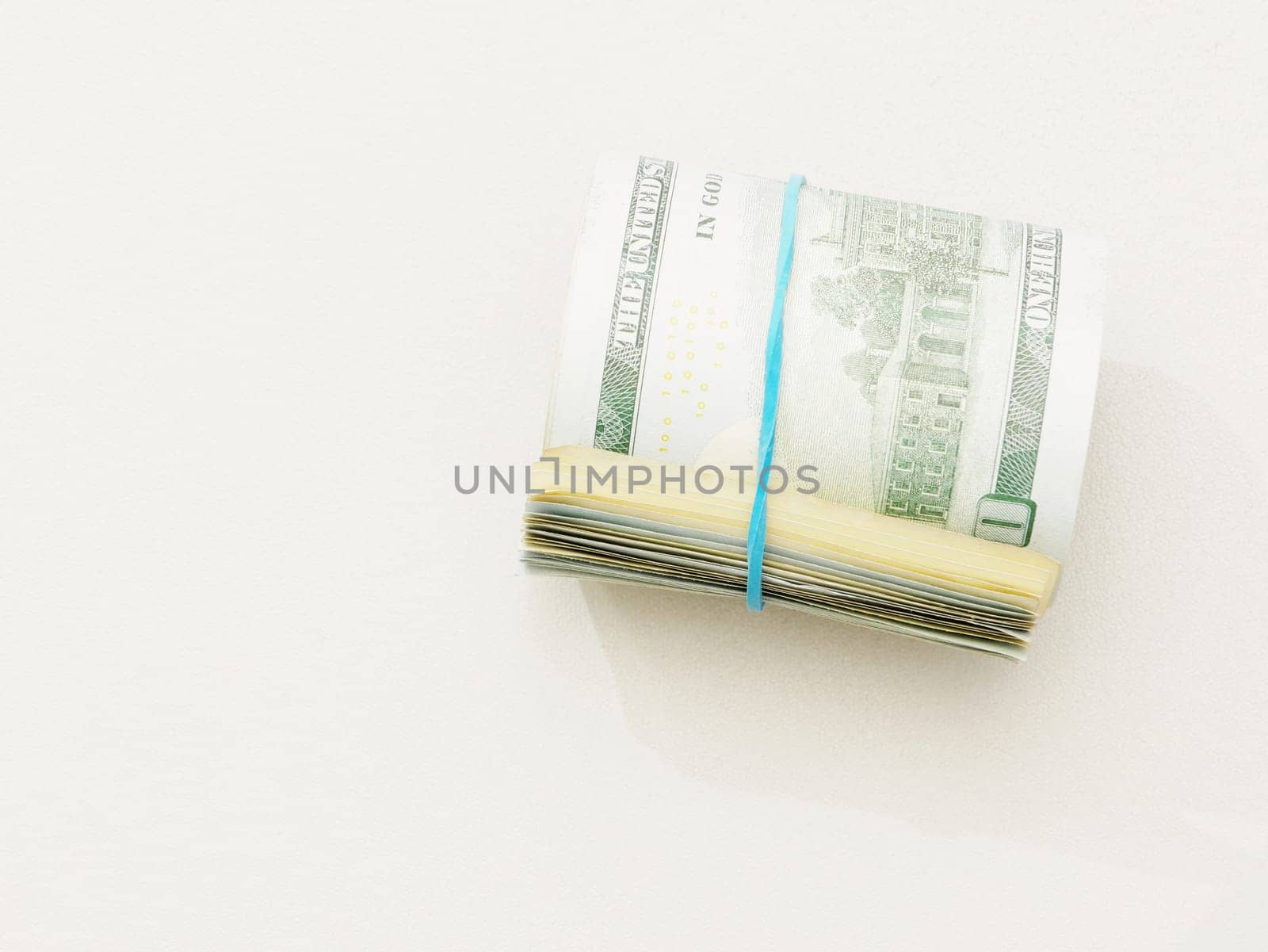 Rolled up dollar bills on a white background. by gelog67