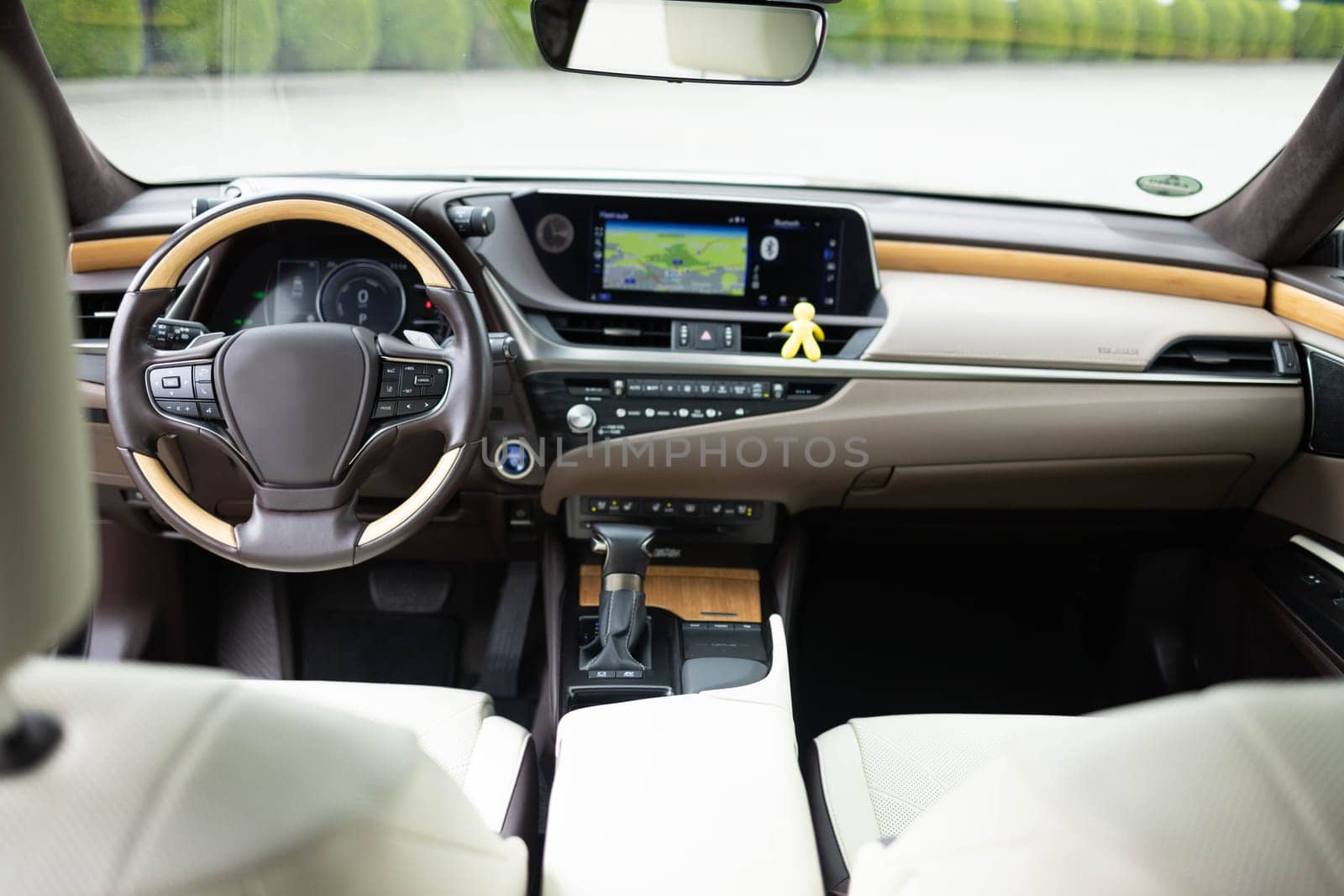 Luxury car interior. Car detailing series. Prestige modern car. . Inside car interior with front leather seats, steering wheel, windows, console, gear shift, electric buttons, digital speedometer.