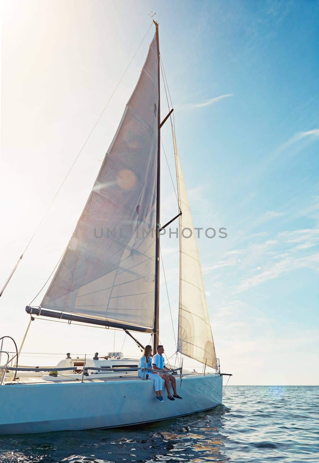 Ocean, travel and boat in the outdoor with couple for adventure on luxury sea journey. Together, water and transport on yacht with rich lifestyle on a cruise in summer for a holiday with waves