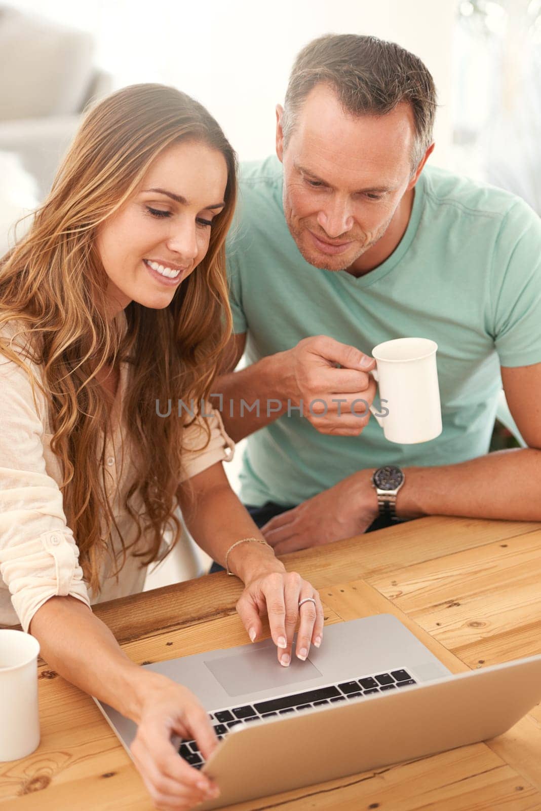 Mature couple, home and laptop for online planning, digital review and check website or application for information. Happy woman or people scroll, reading or search on computer with coffee or tea.