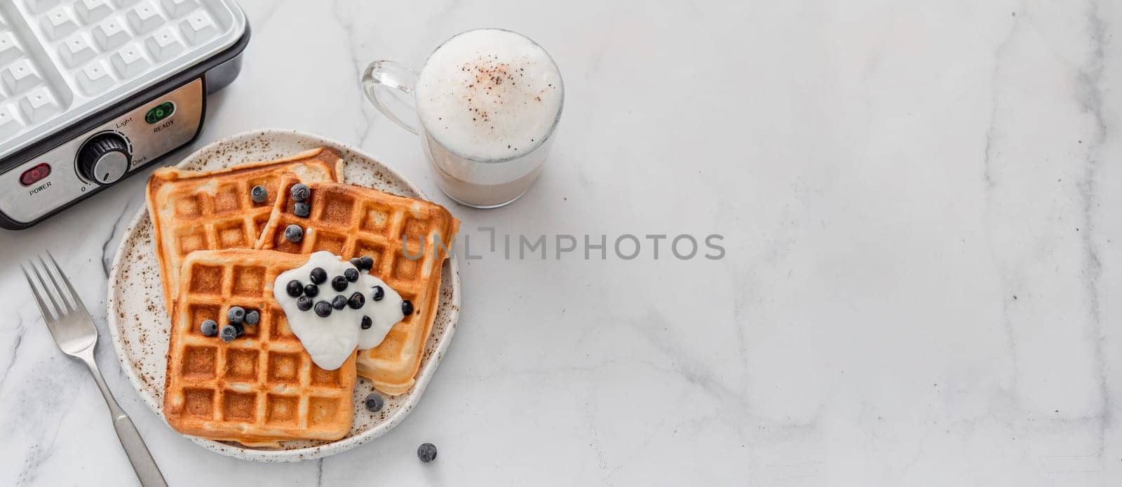 Breakfast belgian waffles, waffle maker. Copy space by fascinadora