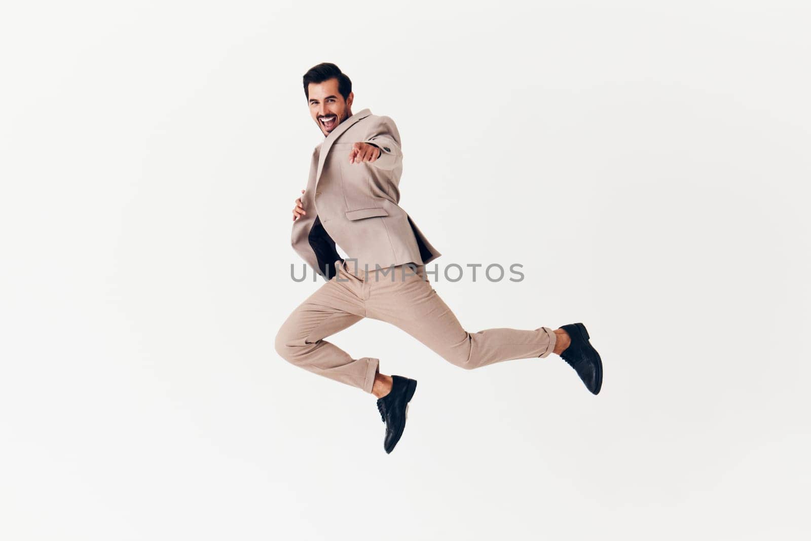 happy man professional suit attractive arm background tie copyspace flying beige jumping winner smiling running businessman young smile business victory isolated