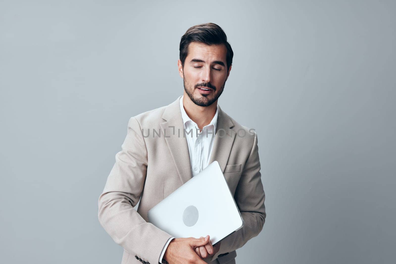typing man beige smile stylish laptop smiling work adult job computer professional technology business copyspace freelancer suit corporate internet young cheerful