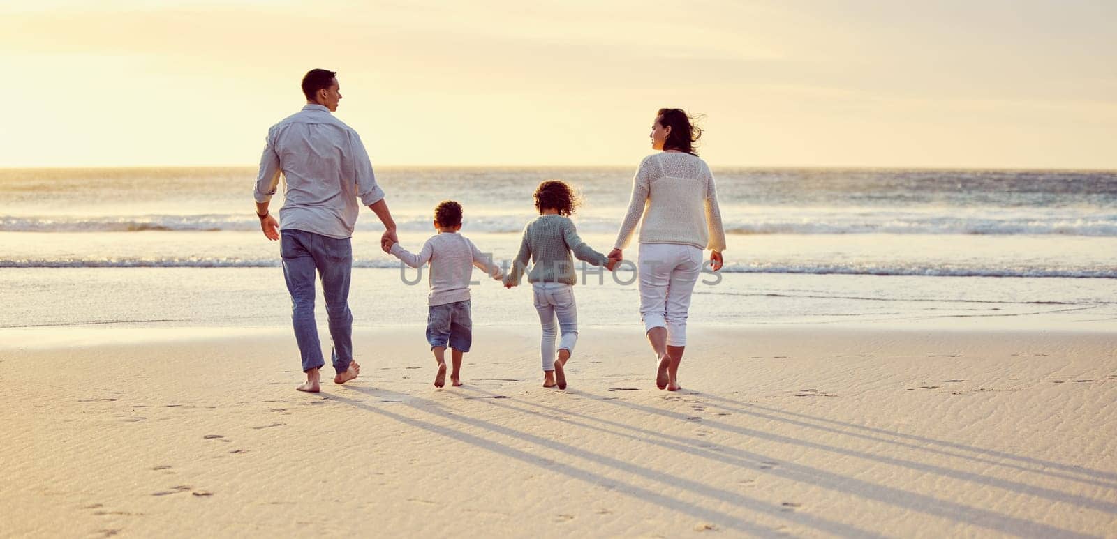 Sunset, walking on beach and family holding hands on holiday, summer vacation and weekend. Nature, travel and mother, father and children by ocean for bonding, adventure and quality time together.