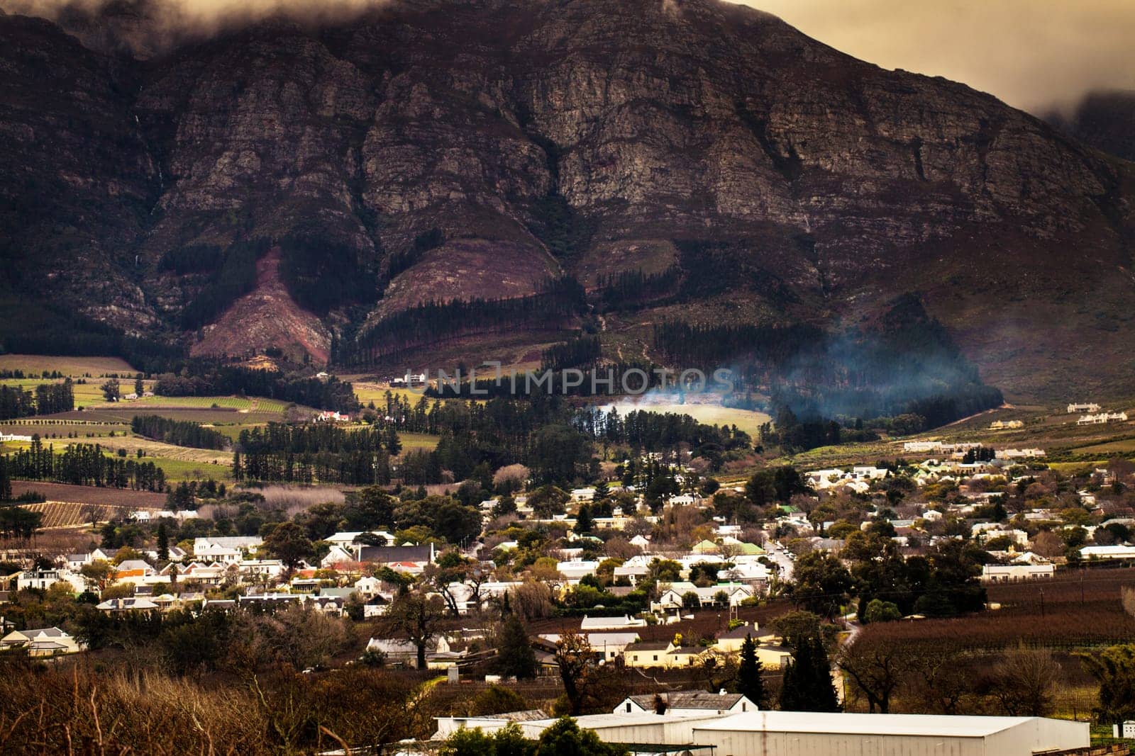 Urban development, suburb or cityscape by mountain, buildings and housing in Cape Town. Outdoor, landscape and mountains with houses, night and hill for real estate, property or holiday by skyline by YuriArcurs