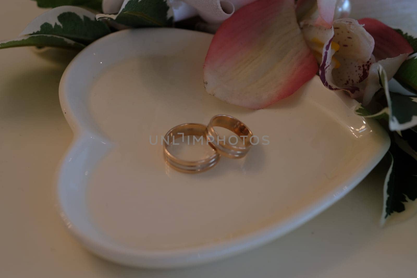 Wedding rings on a white saucer. High quality photo