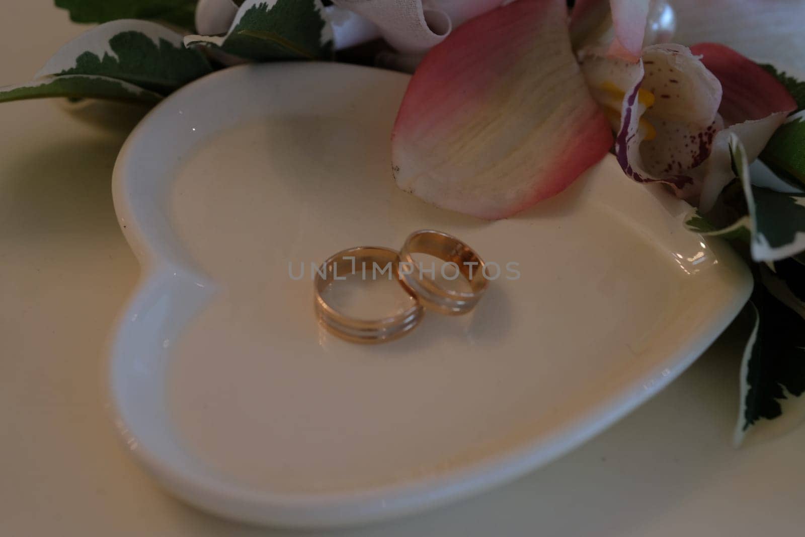 Wedding rings on a white saucer. High quality photo