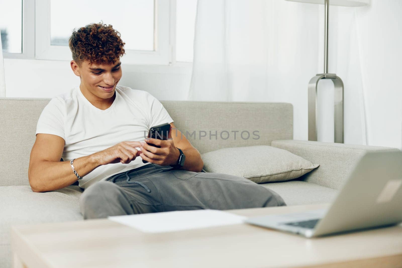man message blogger sports holding text message laptop person blissful selfies student home cyberspace phone male