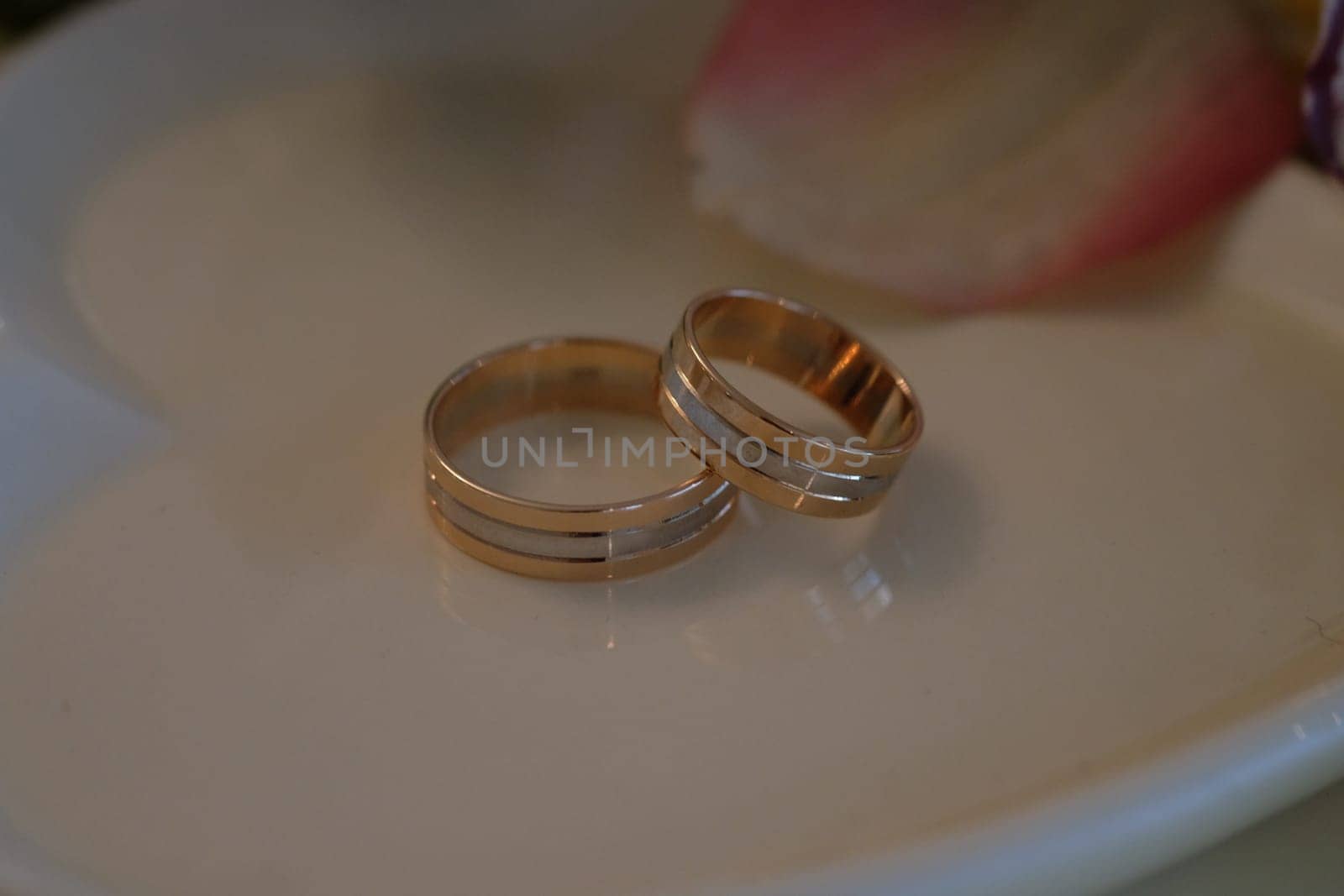 Wedding rings on a white saucer. High quality photo