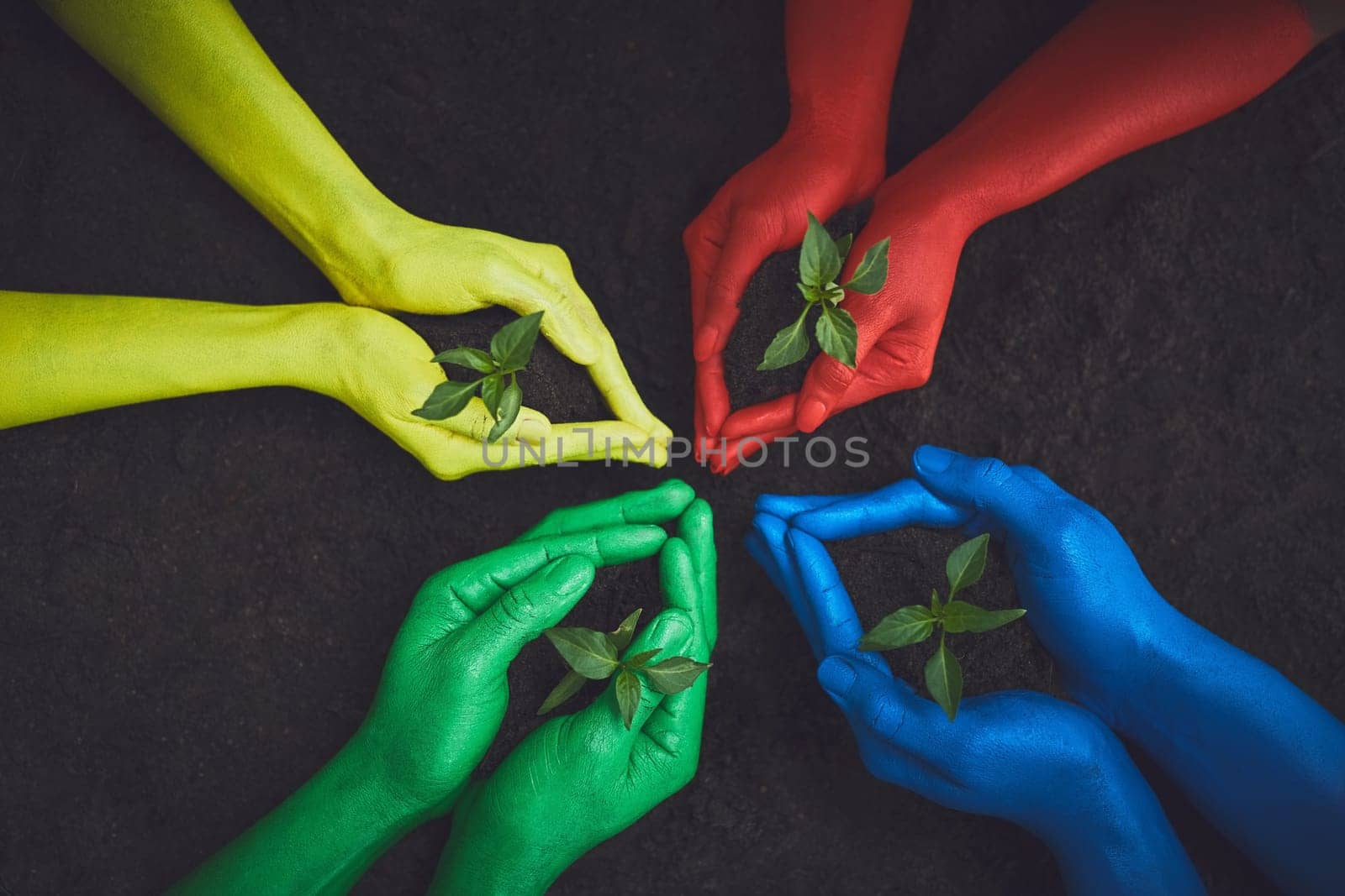 The color of nature. unrecognizable people holding budding plants in their multi colored hands. by YuriArcurs