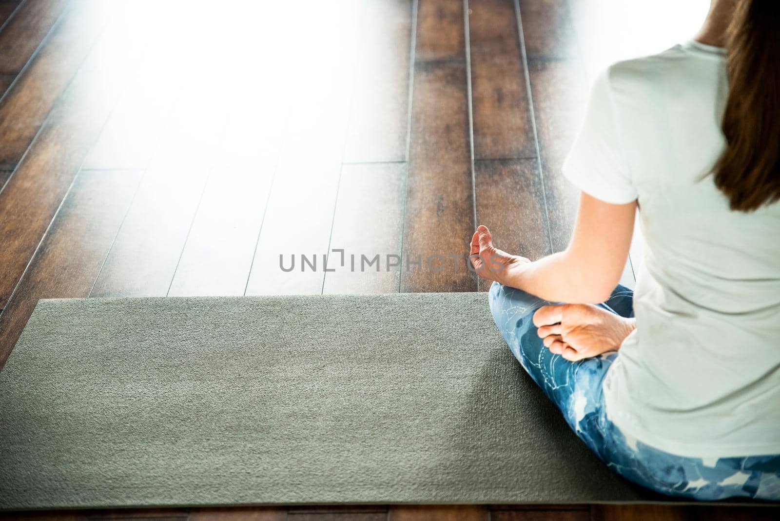 Young woman meditating sitting in lotus position