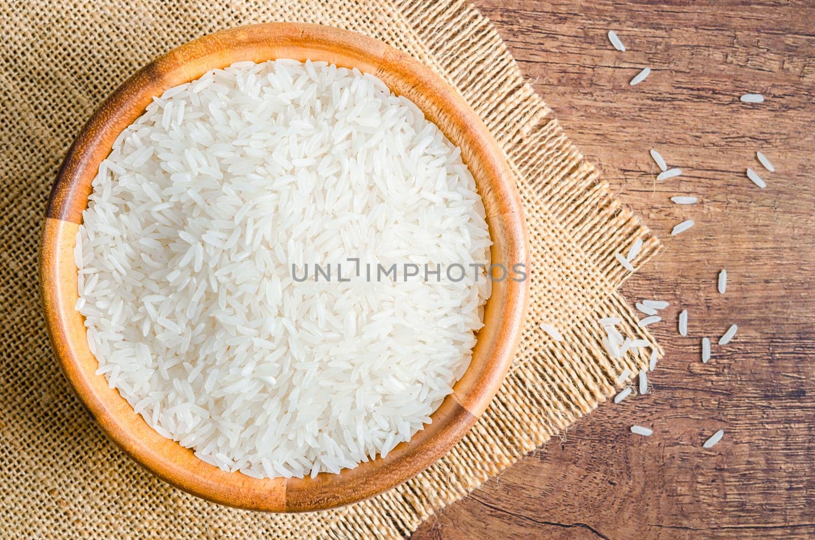 Organic Thai Jasmine rice grain in wooden bowl preparing for cooked