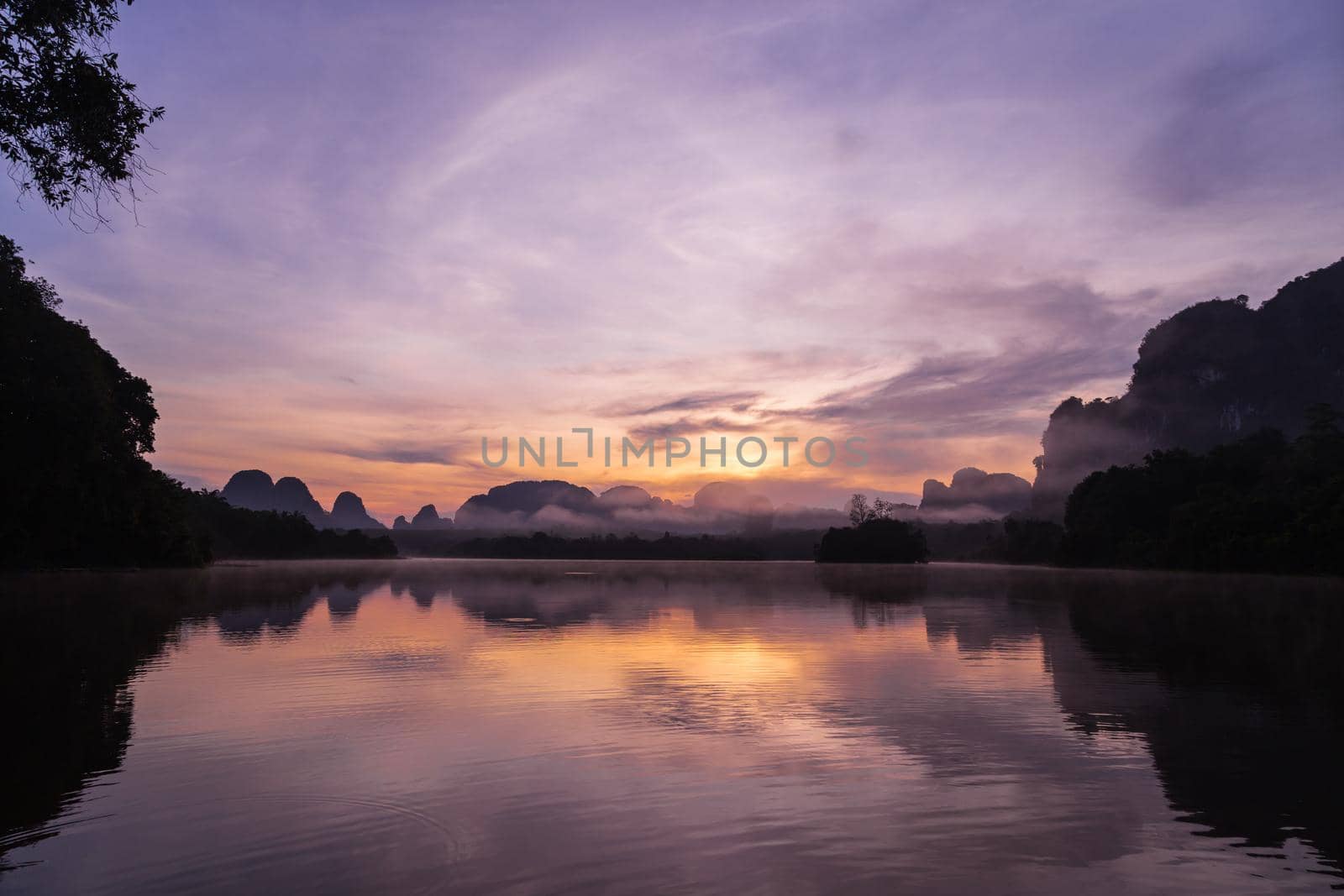Ban Nong Thale the natural scenery of the sunshine in the morning (mountains, lakes, trees, fog) at Krabi, Thailand.