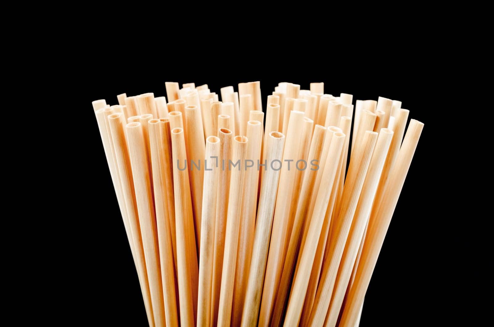 Close up wheat straw for drinking water on black background. Zero waste concept.