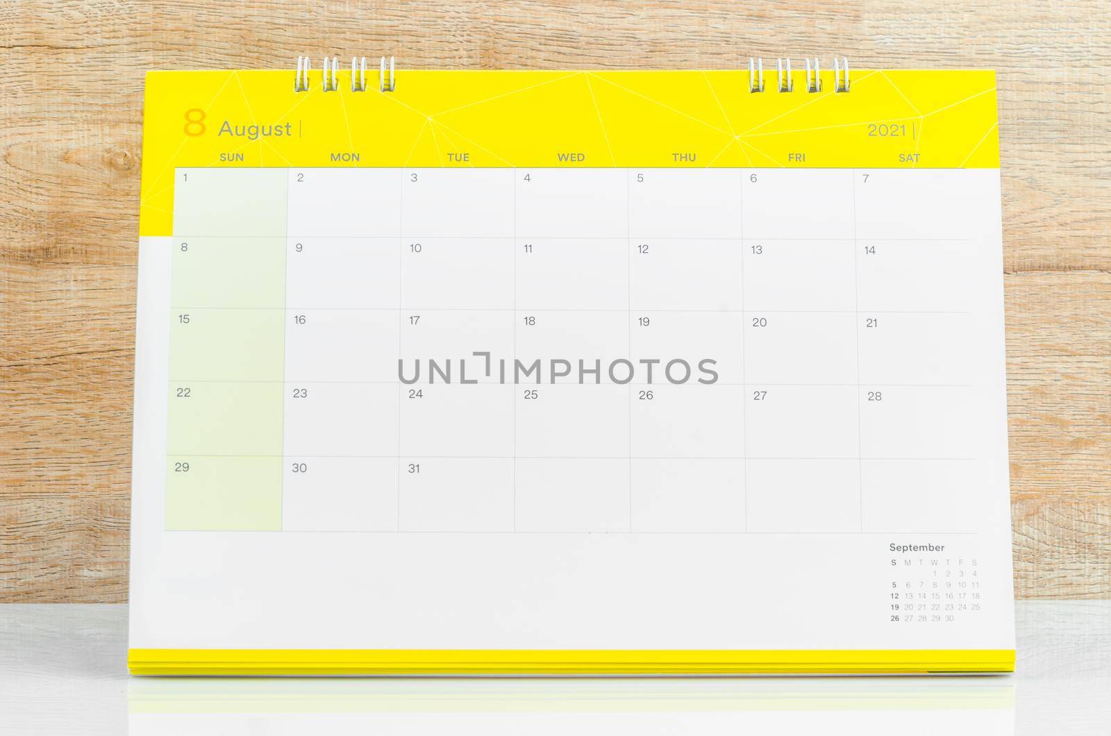 August Calendar 2021 on wooden table background.