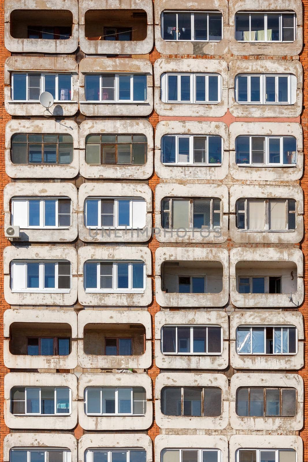 full frame background and texture of typical mid-russian concrete and brick high rise condominium residential building.