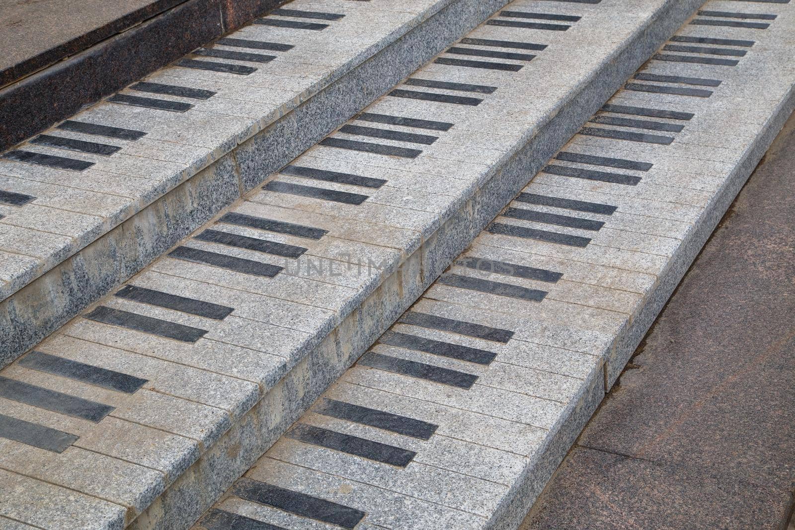 public granite stairs stylised as piano keys - close-up view with diagonal composition