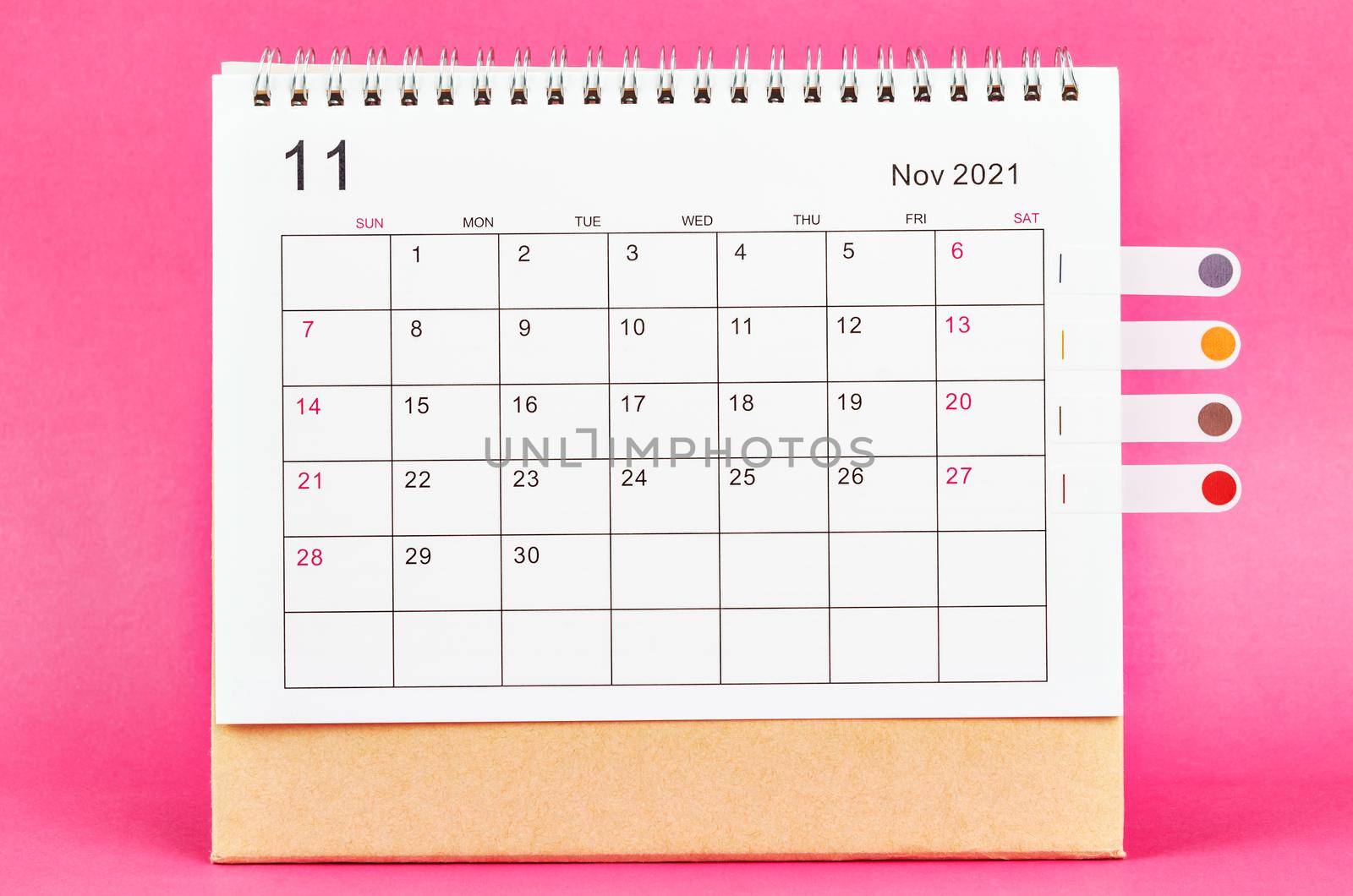 November 2021 calendar on pink background.