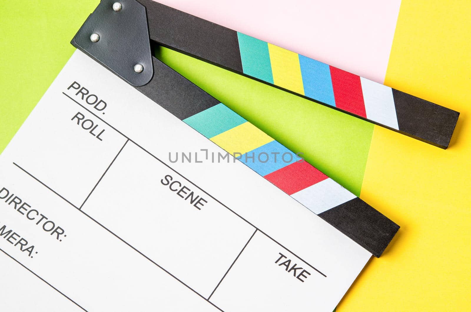 Filmmaker profession. Clapperboard on colorful background