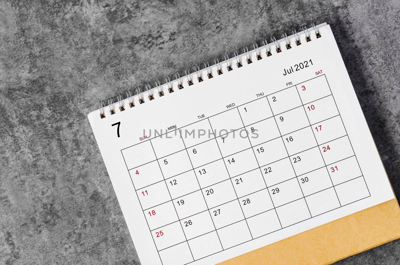July Calendar 2021 on wooden table background.
