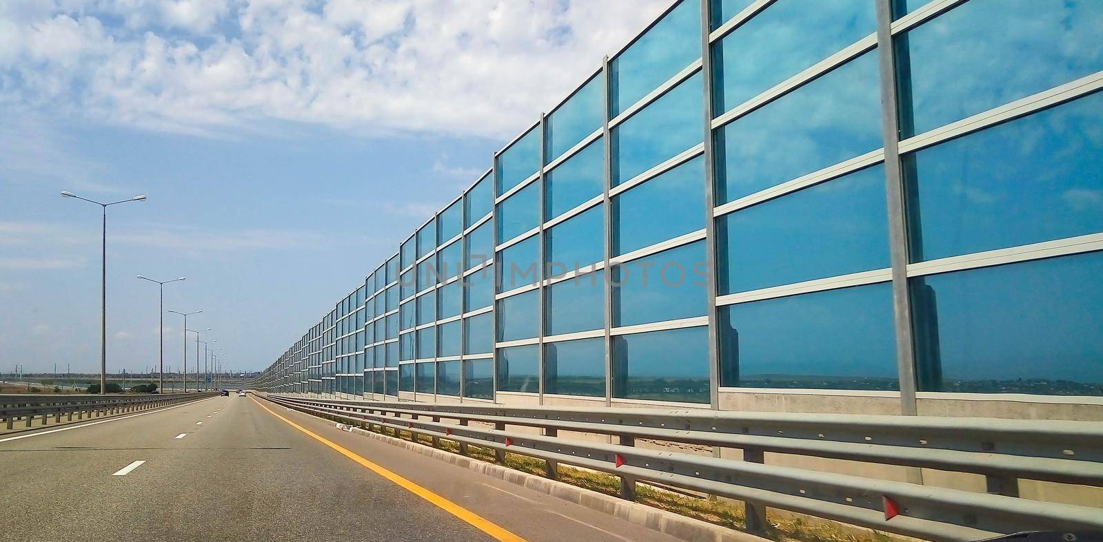 Modern architecture of the highway and the glass barrier.