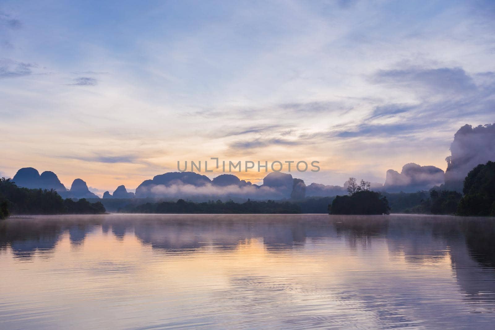 Ban Nong Thale the natural scenery of the sunshine in the morning (mountains, lakes, trees, fog) at Krabi, Thailand.