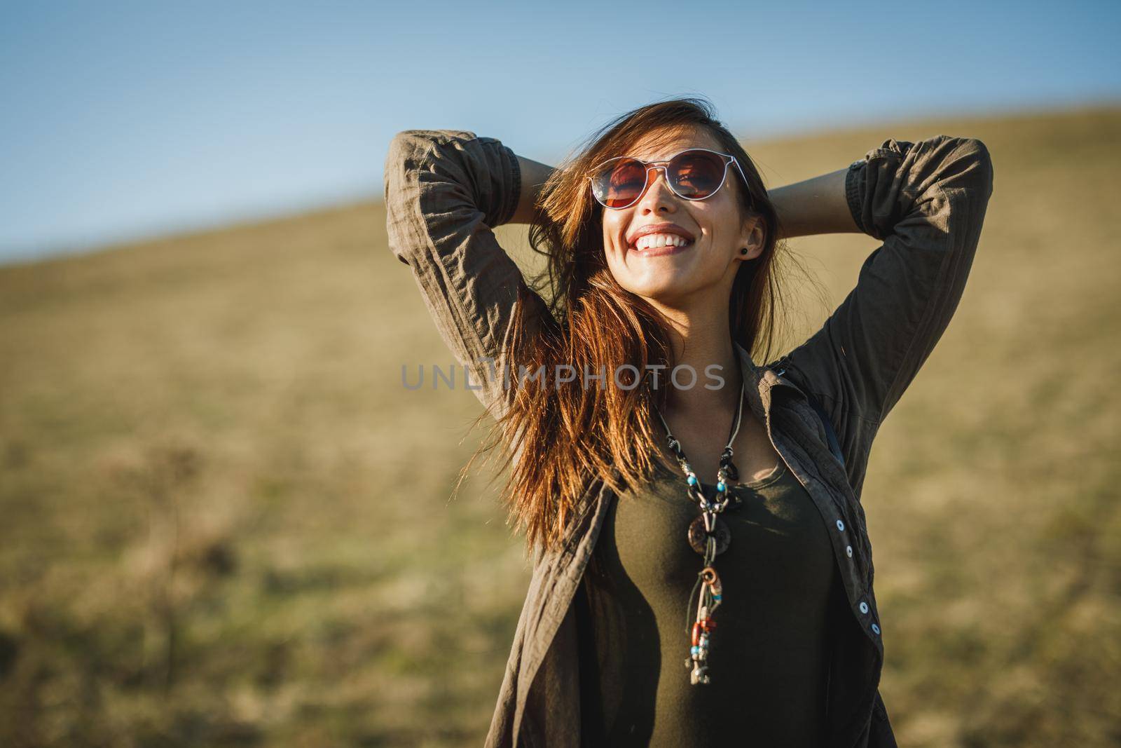 Shot of a smiling young woman enjoying the outdoors.