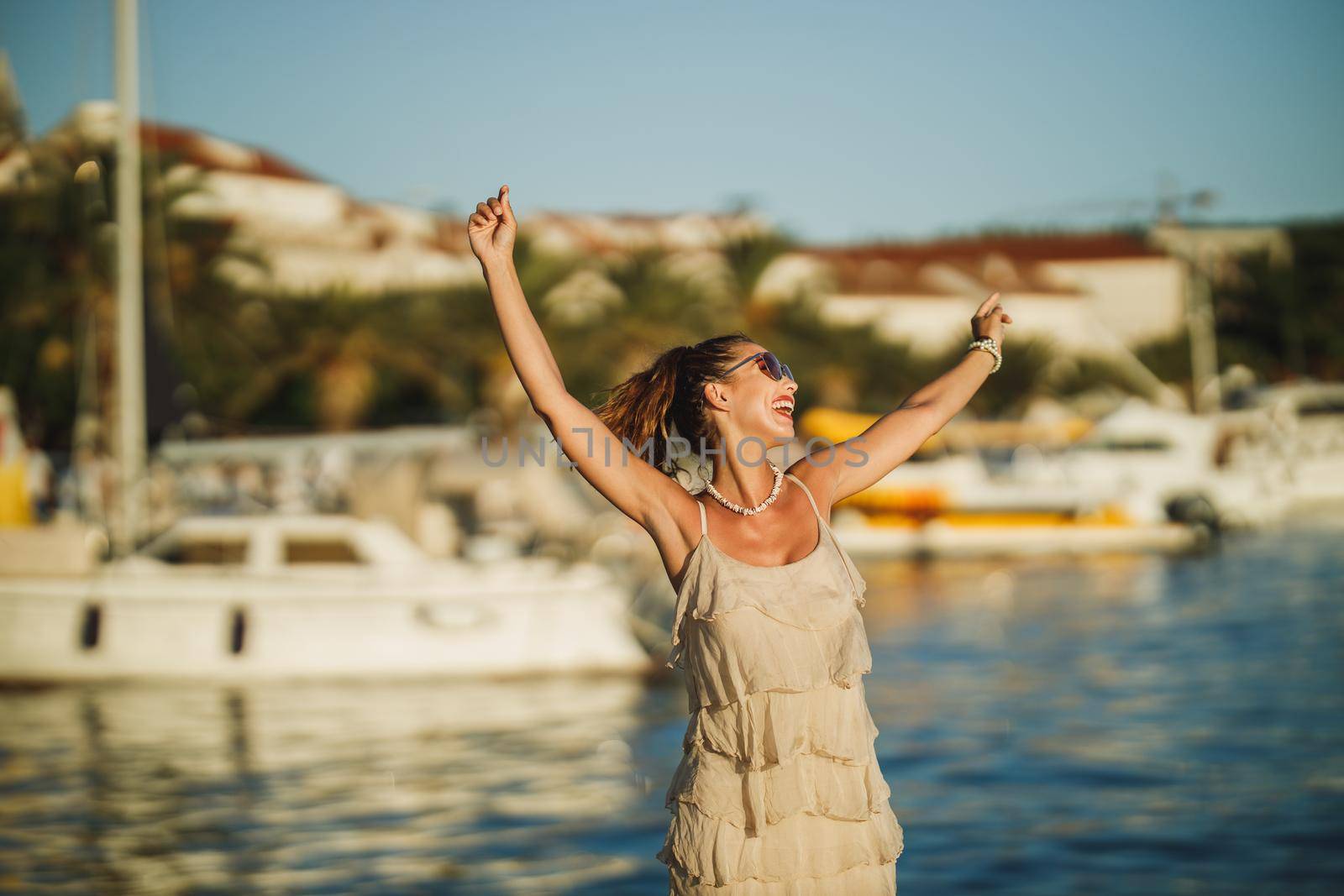 An attractive young woman enjoying a summer vacation while exploring the wonderful seaside of Meditteranian.