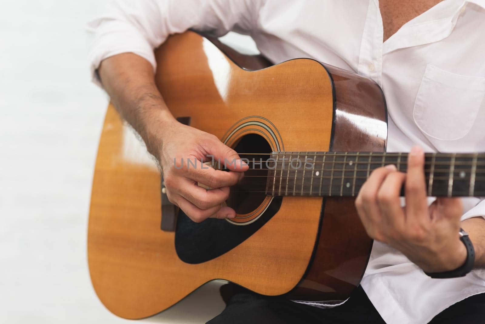 man playing acoustic guitar on white background