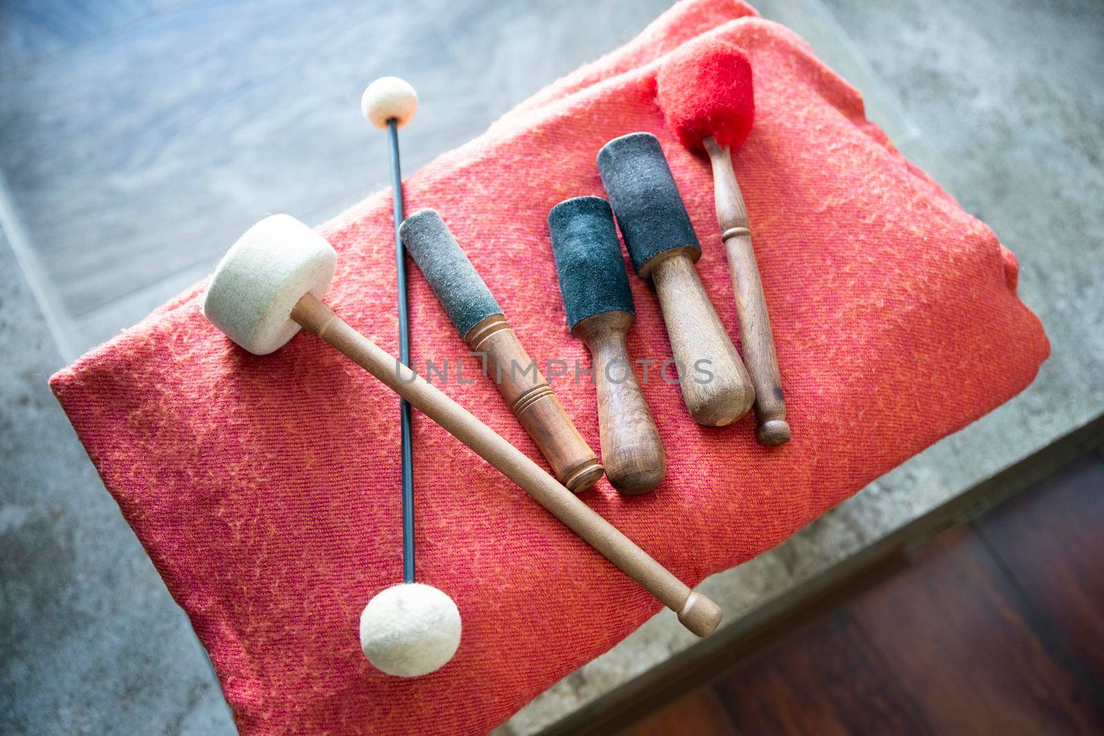 wooden sticks for sound therapy with singing bowls in spa salon