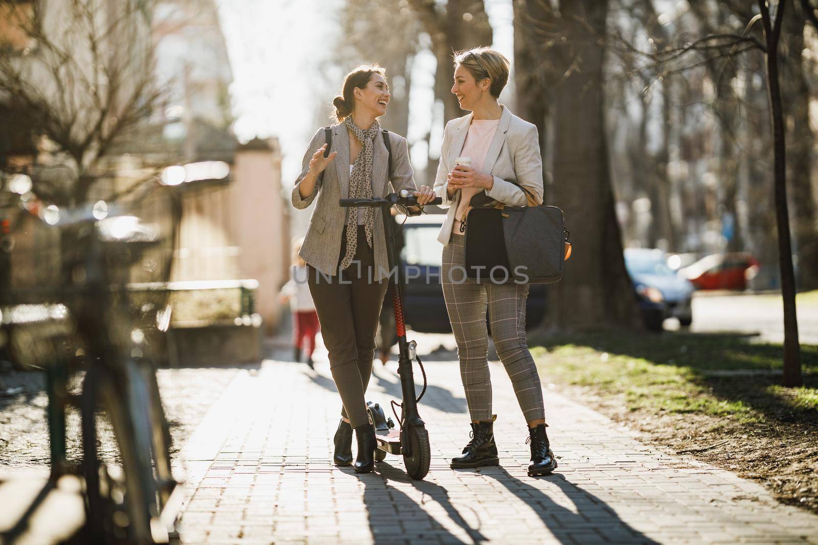 A two successful businesswomen chatting while walking through the city.