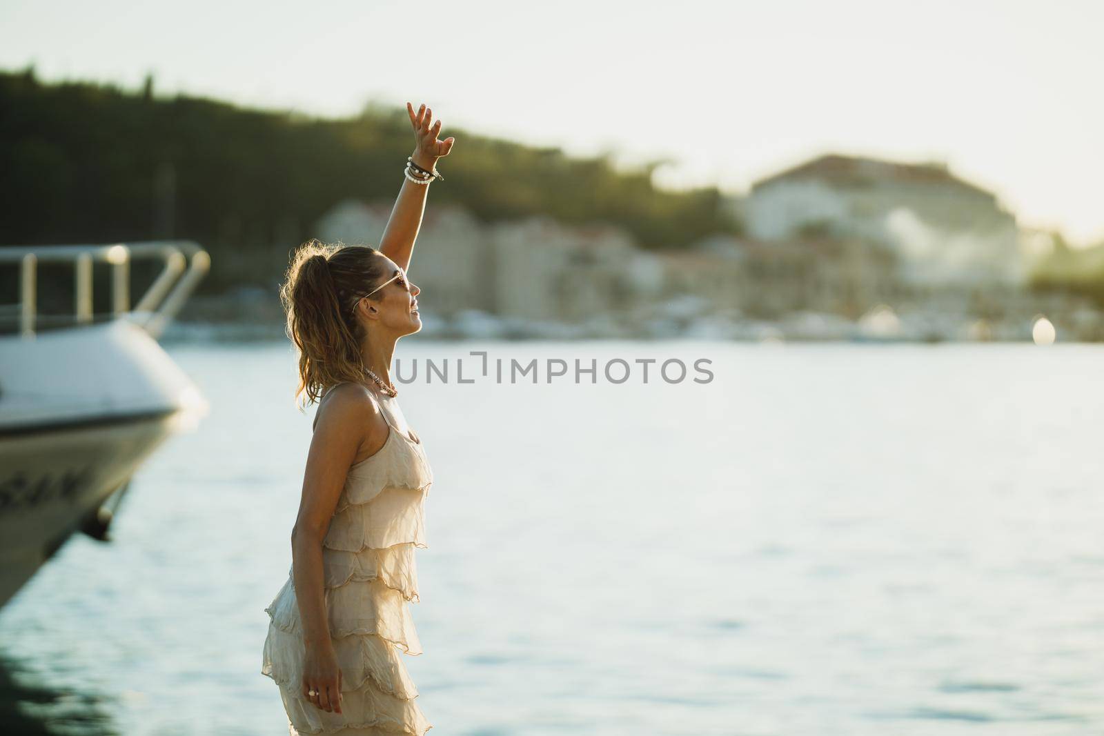 An attractive young woman enjoying a summer vacation while exploring the wonderful seaside of Mediterranean.