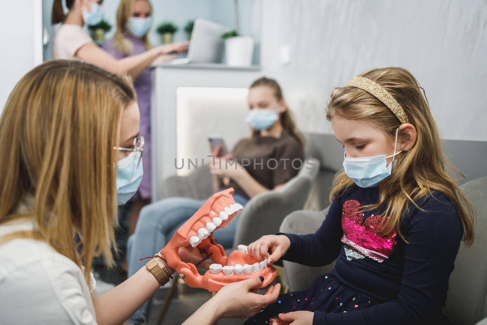 Dentist Show Model Of Teeth To Kid Patient by MilanMarkovic78