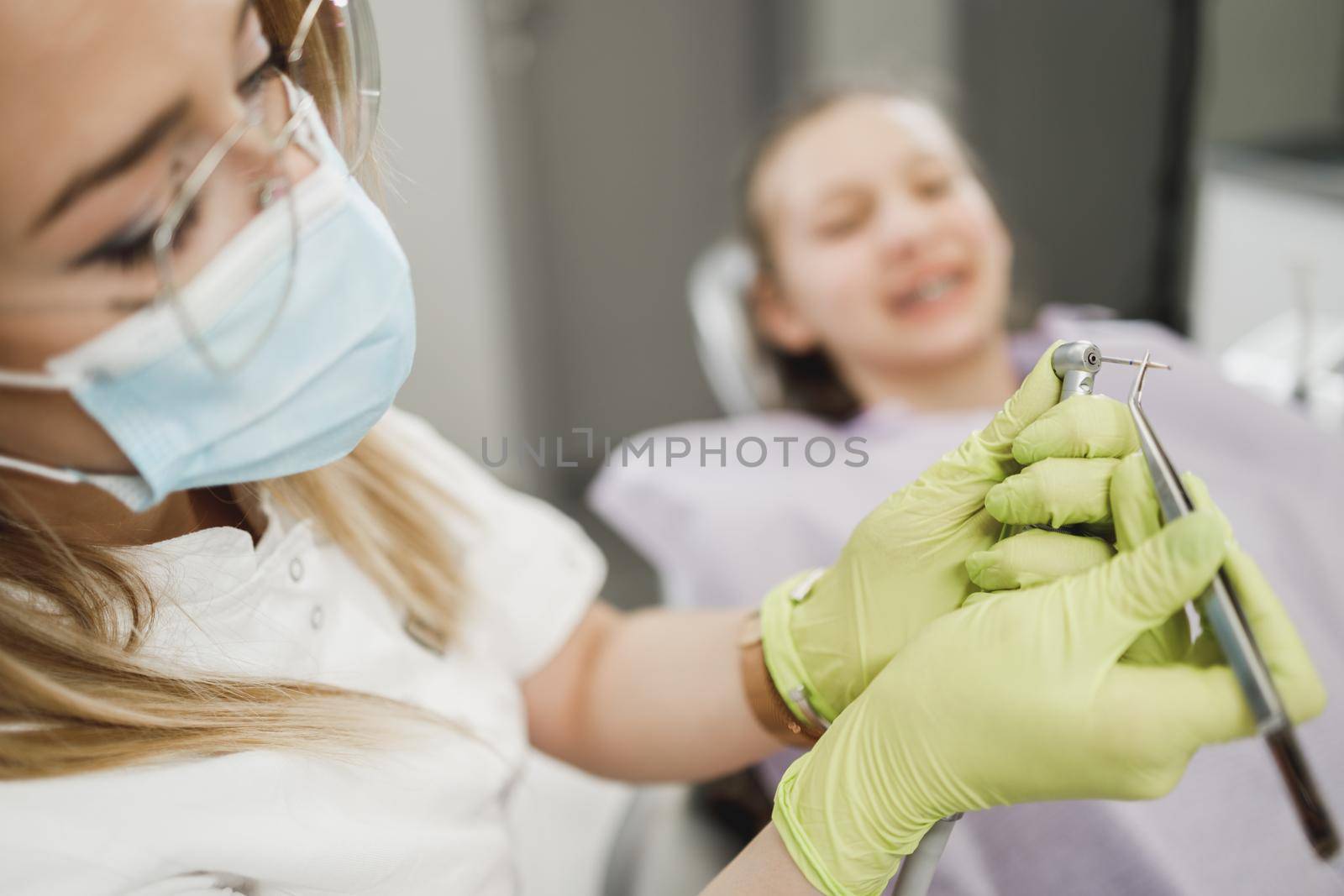 Shot of an unrecognisable dentist holding dental tools in an office.